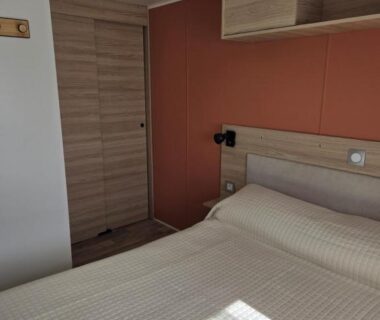 Chambre avec lit double et rangement dans le FMLODGE mobil home soleil et sieste