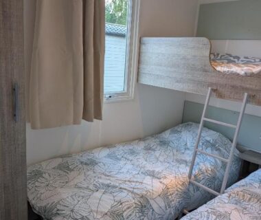 Chambre avec lits superposés et deux lits simples dans le Ferret Family Lodge du camping Les Embruns