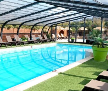 Piscine couverte avec transats et pots verts au Glamping Terre et Mer