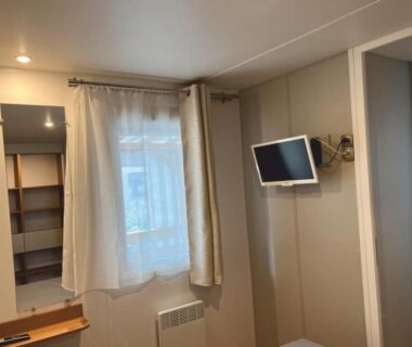 Intérieur avec fenêtre télévision et rangement dans le Grand mobile-home 45M2 au calme et au bord de mer