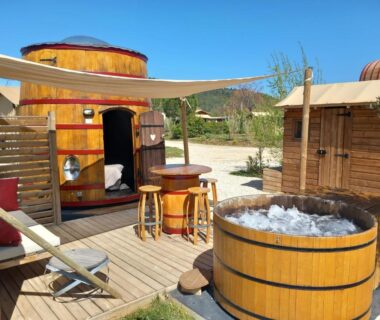 Terrasse en bois avec bain à remous et coin repas de l'hébergement Hébergement Insolite avec SPA Foudreaterre