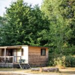 Mobil-home en bois sur terrasse au camping Huttopia Les Châteaux