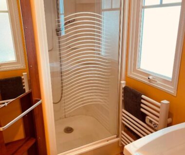 Salle d'eau avec cabine de douche et lavabo du Joli Mobil-Home de Vacances