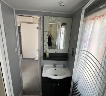Salle de bains avec lavabo et cabine de douche dans l'hébergement L éden