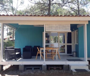 Terrasse couverte avec salon et table du chalet LOUE JOLI CHALET EN BOIS POUR 2 PERSONNES AU CHM de MONTALIVET
