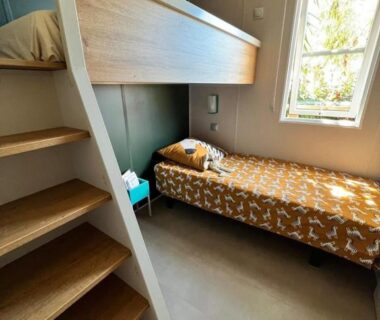 Chambre avec lits superposés et fenêtre dans La Cabane de Bob