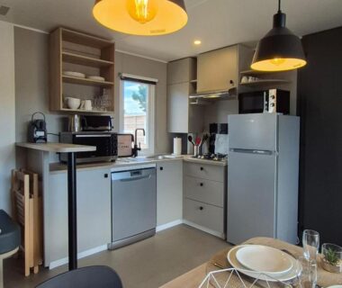 Cuisine équipée avec table et électroménagers dans le mobil home La Dolce Vita Méditerranéenne