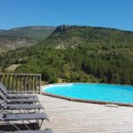Terrasse piscine avec chaises longues dans La Ferme de Clareau Glamp'In Lodge Nature
