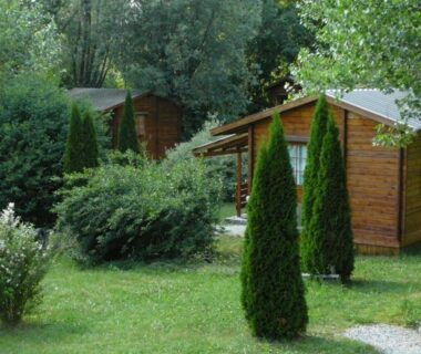 Chalets en bois dans un jardin arboré au camping La Valière