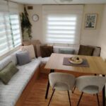 Coin repas avec banquette et table dans le locatif du camping Le Bruant des Roseaux