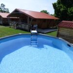 Piscine ronde hors sol et chalets en bois au camping Le Carbet Vendéen
