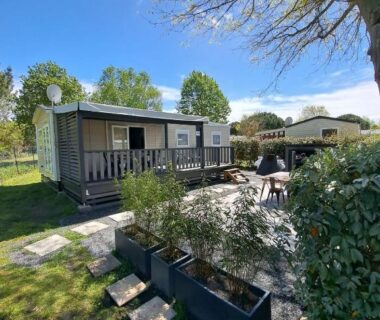 Mobilhome avec terrasse et plantes dans le camping Le Cozy'Land – Mobilhome Camping La Réserve