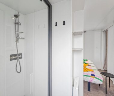 Salle d'eau avec douche et chambre du logement Le Nocia