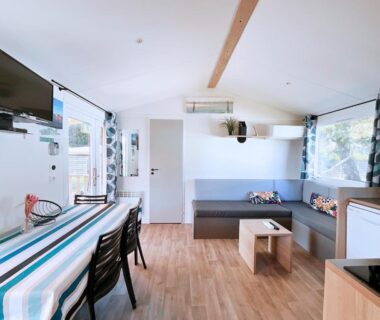 Intérieur avec coin salon et table dans Le Ti Buch Mobilhome