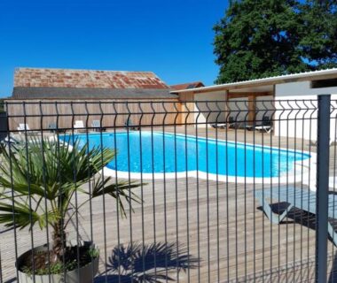 Piscine extérieure avec terrasse en bois au camping Les 5 Étangs