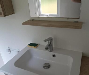 Lavabo et robinet près de la fenêtre dans l'hébergement Les Ch'tis Normands 2