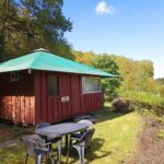 Terrasse et mobilier de jardin devant cabane en bois aux Cabanes de l'île aux oiseaux Guern