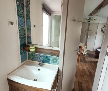 Salle de bains avec lavabo et miroir dans le Logement 3 chambres Vue Lac Camping 4 étoiles Foix