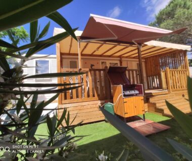 Terrasse en bois avec barbecue et auvent au camping MAR ESTANG