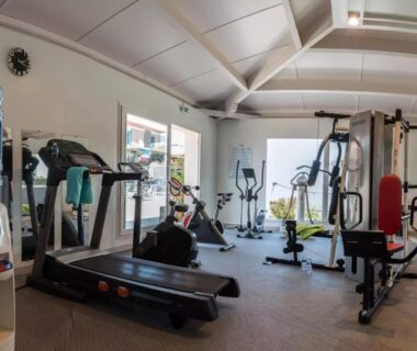 Salle de sport avec tapis de course et vélos d'appartement au Mobil Home Camping Les Sables du Midi 3 chambres