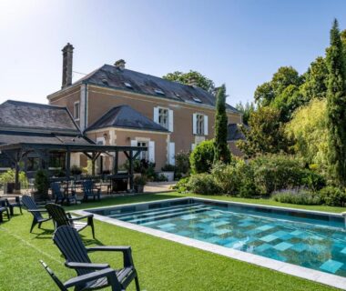 Piscine extérieure avec chaises longues et jardin au Manoir le Mingreaud Bungalows