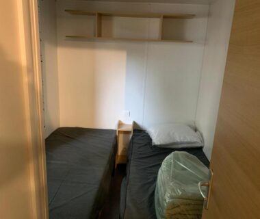 Chambre avec deux lits simples et table de chevet dans le Mobil-Home -10 minutes Océan