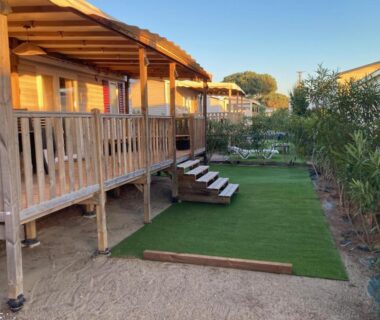 Terrasse en bois avec pelouse, escaliers et chaises du Mobil Home 4-6 personnes