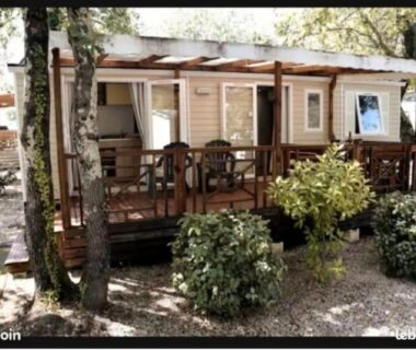Terrasse en bois avec chaises sous arbres du Mobil-Home Camping 6 personnes ARDECHE Le Domaine de Chaussy
