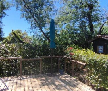 Terrasse en bois avec transat et végétation au Mobil Home Golf de Saint Tropez