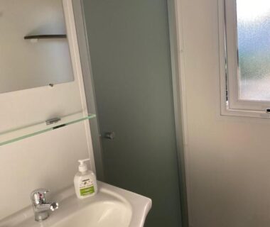 Salle de bain avec lavabo et douche dans le Mobil-Home Les Terrasses Vias Plage