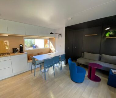 Intérieur avec salon coin repas et cuisine ouverte du Mobil Home camping La Civelle
