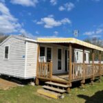 Extérieur avec terrasse couverte et pelouse du Mobil Home tout confort 6 personnes avec wifi