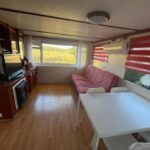 Séjour lumineux avec canapé kitchenette et table dans le mobil-home