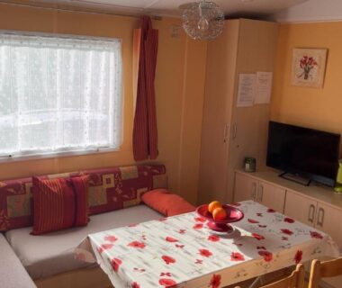 Salon avec table et télévision dans le mobil home