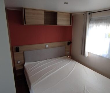Chambre avec lit double et fenêtre dans le Mobil-home 40m2