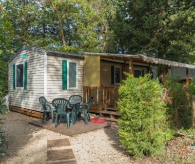 Terrasse ombragée avec table et chaises devant le mobil-home