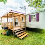 Sur la pelouse mobil-home avec terrasse du Mobil-home 6/8 personnes Camping Siblu Domaine de Dugny