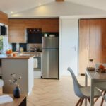 Intérieur séjour avec cuisine et coin repas du Mobil-home 8 personnes camping PONT AVEN