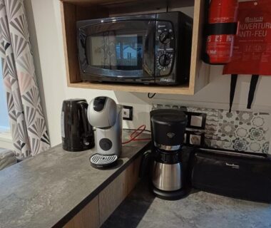 Coin kitchenette avec micro-ondes cafetière filtre machine à capsules et bouilloire dans le mobil-home Camping Siblu La Reserve