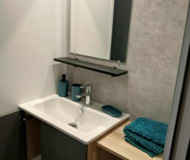Salle de bains avec lavabo miroir et serviettes du mobil-home Clim Camping Marisol