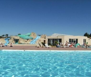 Piscine extérieure avec toboggans et terrasse au Mobil-home Dan Dom