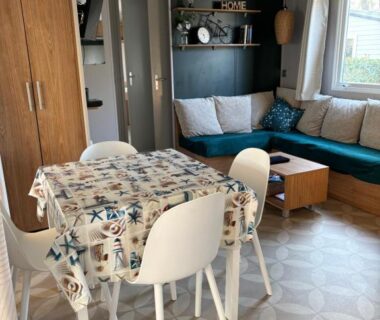 Intérieur salon avec coin repas et canapé du Mobil home Domaine de Kerlann