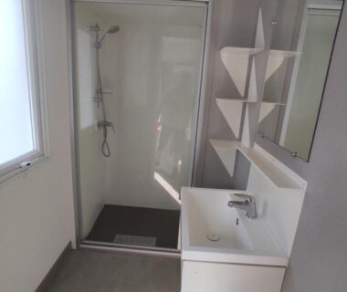 Salle de bain avec douche lavabo et miroir du Mobil home Houlgate