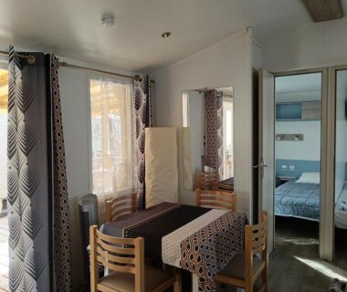 Intérieur avec coin repas et chambre visible du Mobil home Lacanau entre Lac et Océan 3 ch 6 p