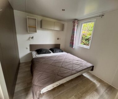 Chambre avec lit double et rangements du mobil home Ouistreham