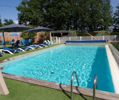 Piscine extérieure avec transats parasols et toboggan au Mobil-home PMR