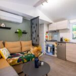 Intérieur salon avec kitchenette et canapé dans le Mobil home Queen Margaret