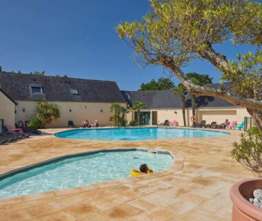 Espace piscine extérieur avec bassin et transats au Mobil home XL 6 personnes Camping 4 étoiles La Pommeraie de l'Océan