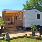 Terrasse en bois avec salon de jardin et plantes du mobil home camping luxe 4 étoiles