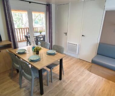 Séjour avec table à manger canapé et télévision du mobil-home climatisé 6 personnes